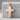 Proverbs 31:25 Scripture Cross Pendant, rose gold plated silver, front view on stone