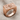 SOA Skull Ring, rose gold, angled front view on fabric