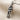Dancing Couple Pendant, oxidized silver, angled front view on textured fabric