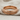 Rope Wedding Ring, rose gold, angled view on fabric