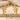 Whisper Bones Earring, gold vermeil, pair displayed on stone surface