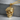 Skull Beret Pendant, gold vermeil, product photo on concrete surface