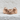 Smiling Frog Ring, rose gold, front view on textured surface