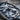 Leaf mask pendant, oxidized silver, close-up of facial relief and leaf details