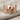 Spread Winged Skull Ring, rose gold, front view on linen fabric