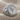 Aquarius Skull Ring, polished silver, angled product view on fabric