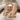 Crossed Axes Skull Ring, rose gold, angled view on fabric