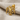 Hittite Double Headed Eagle Earring, gold vermeil, front view on fabric
