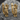 Comedy Tragedy Earring, gold vermeil, pair displayed on stone surface