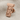 Göbeklitepe pillar lapel pin in rose gold vermeil, front view on fabric