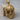 Angel Skull Pendant, gold vermeil, product photo on wood display
