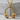 DJ headphones pendant, gold vermeil, product photo on stone stand