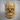 Baroque Foliage Skull Ring, gold vermeil, front view on wood