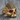 Jeweled Skull Ring, gold vermeil, angled front view on wood