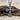 Trefoil Cross Pendant, oxidized silver, angled on driftwood and sand