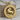 Taurus Zodiac Wheel Pendant, gold vermeil, front view on wood block