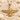 Ahura Mazda Faravahar Pendant, gold vermeil, resting on sand with seashells