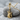 Horns Skeleton Guitar Pendant, gold vermeil, resting on stone