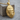 Primate Head Pendant, gold vermeil, angled view on wood block