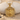 Vitruvian Man Halo Pendant, gold vermeil, front view resting on sand