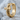 Studded Gothic Cross Earring, gold vermeil, angled view on stone