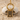 Boy doll pendant, gold vermeil, product photo on sand and pebble
