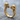 Twin Skull Ring, gold vermeil, angled view on rock surface