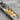 Turning Ember Bar Pendant, oxidized silver, close-up of textured gold fold and black stone