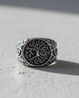 Side view of handcrafted silver ring showing intricate Celtic knotwork and leaf patterns on the band with oxidized finish