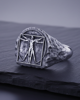 925 sterling silver Vitruvian Man ring with oxidized finish on dark slate background