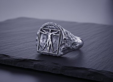 925 sterling silver Vitruvian Man ring with oxidized finish on dark slate background