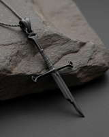 Black rhodium plated sterling silver broken sword pendant with intricate hilt details on stone