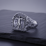 Front view of Silver Vitruvian Man Ring with detailed Leonardo da Vinci relief on slate background