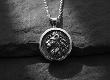 Front view of handcrafted silver lion pendant showing the intricate mane details and dark oxidized finish