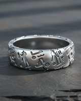 Close up of 925 sterling silver band ring showing detailed ancient Egyptian relief carvings and oxidation