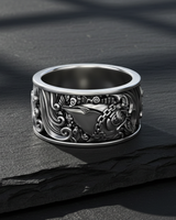 Front view of 925 sterling silver money fish ring with dollar sign detail on dark stone background