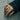 Pisces Twin Fish Ring worn on model hand against concrete wall