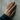 Lifestyle view of a woman wearing the rose gold plated patterned cross ring resting hand on a textured concrete wall