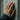 Detailed view of the industrial speaker cone ring worn on a hand resting against a textured grey concrete wall background