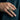 Skull Cluster Ring worn on model's hand against a suit jacket