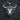 Detailed bull head pendant in sterling silver resting on dark background, highlighting prominent horns and nose ring.