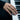 Elegant Yin Yang koi ring worn on a woman's hand resting gracefully on black and white piano keys showcasing its fit