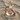 Serpent Gemstone Ring, rose gold plated finish on beach sand