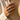 Elegant double band chevron ring worn on woman's hand holding a woven straw hat, showcasing the modern minimalist design