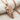Double Horse Skull Pendant, rose gold plated silver, angled view on fabric
