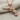 Checkered Grip Revolver Pendant, rose gold, front view on fabric