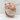 Curled Sleeping Cat Ring, rose plated silver, angled view on textured surface