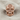 Gothic Rosette Skull Ring, rose plated silver, front view on linen