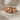 Double Knot Ring, rose gold, close-up view resting on linen fabric