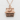 Nagoya Castle Pendant, rose gold, front view on textured background